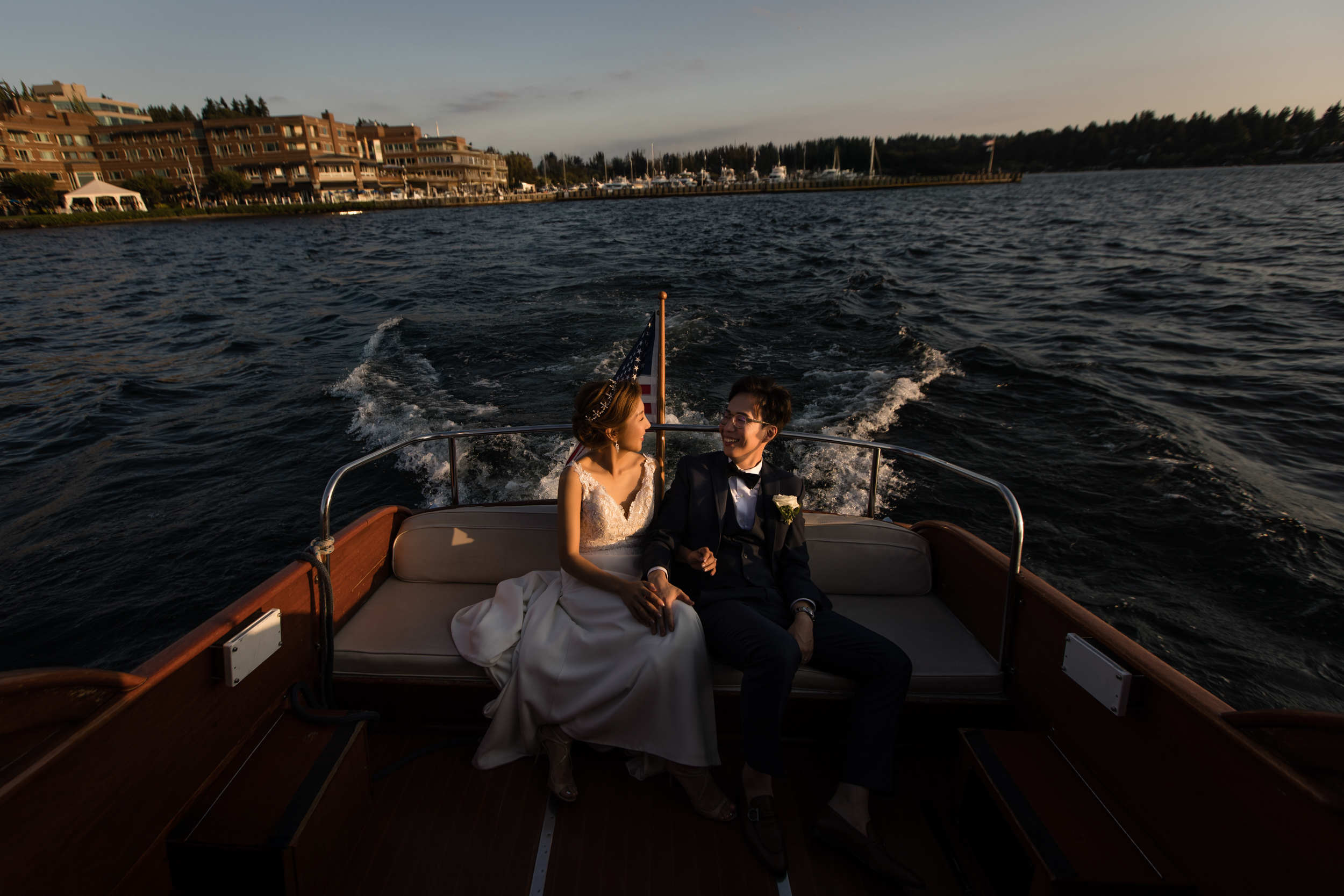 Korean couple in the boat during golden hour at Woodmark Hotel & Spa